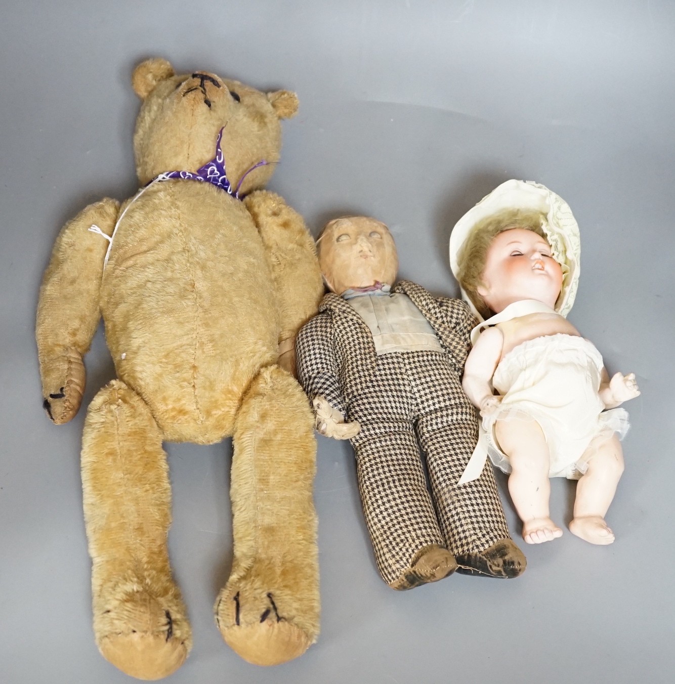 A plush teddy bear a cloth male doll and a bisque headed Armand Mareseille open mouthed doll, doll 23cms high